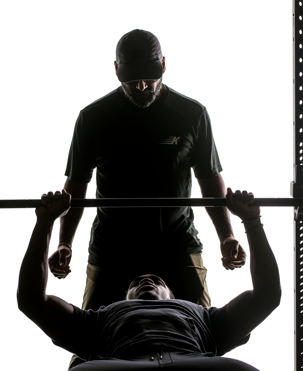kinetic-train-services-landing Kinetic PT training services man bench pressing with spotter